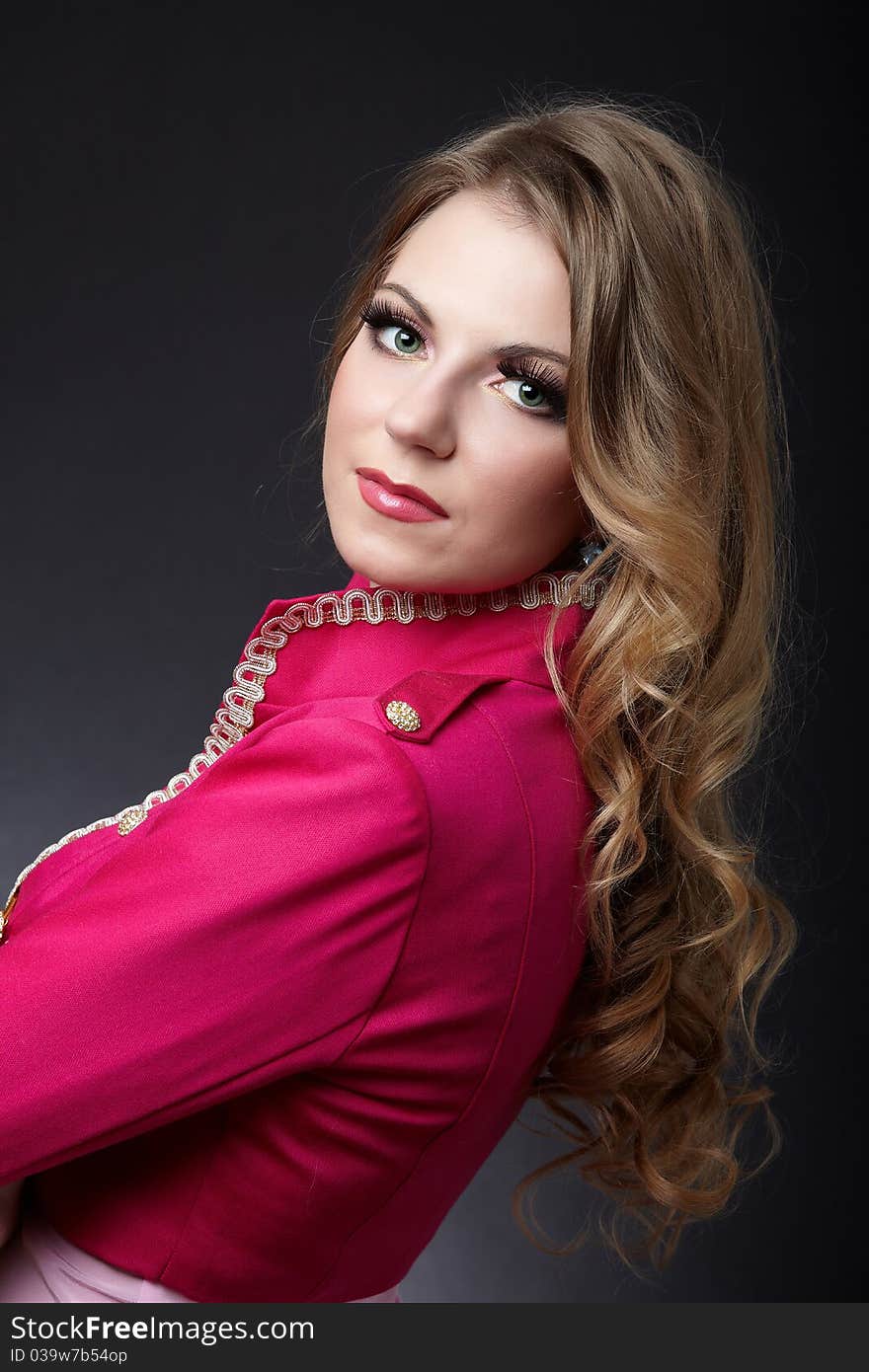 Posh blonde in jacket posing against dark background. Posh blonde in jacket posing against dark background