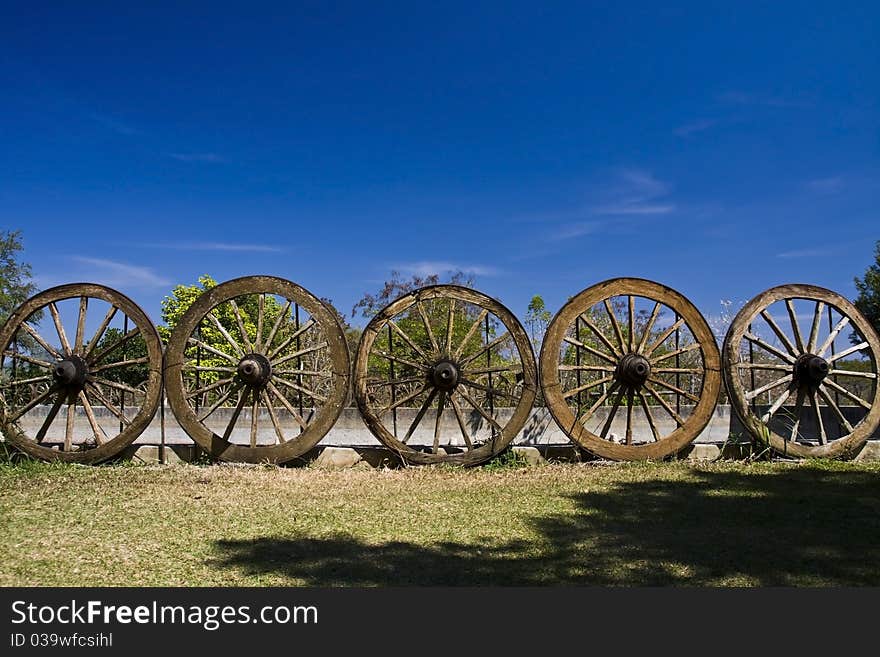 Wagon wheel on cart - abandoned in field. Wagon wheel on cart - abandoned in field