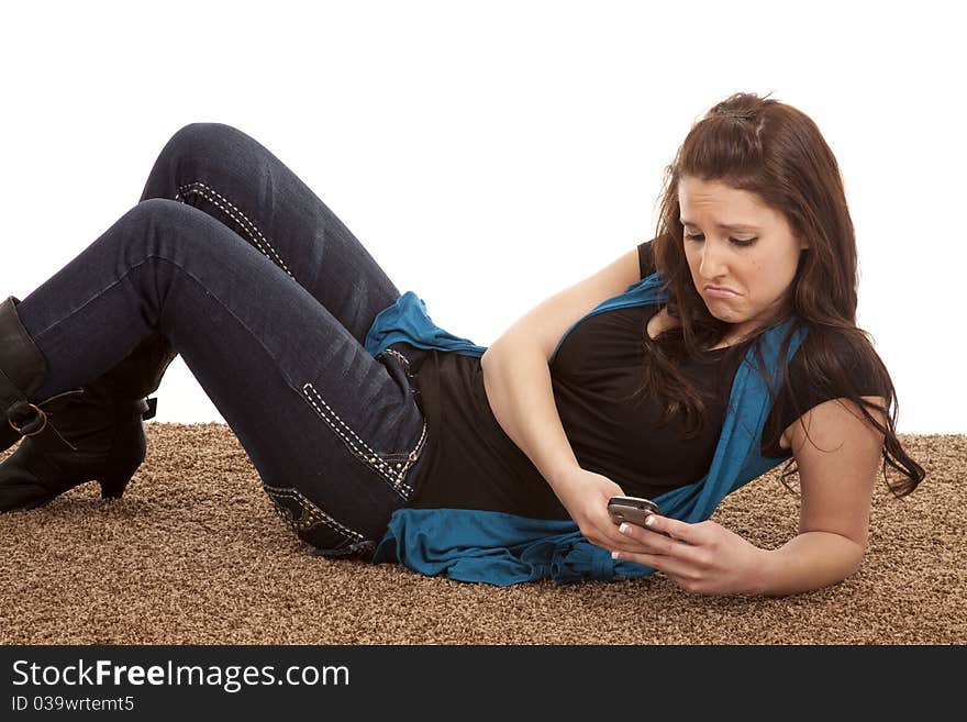 A woman is looking at her phone with a sad expression. A woman is looking at her phone with a sad expression.