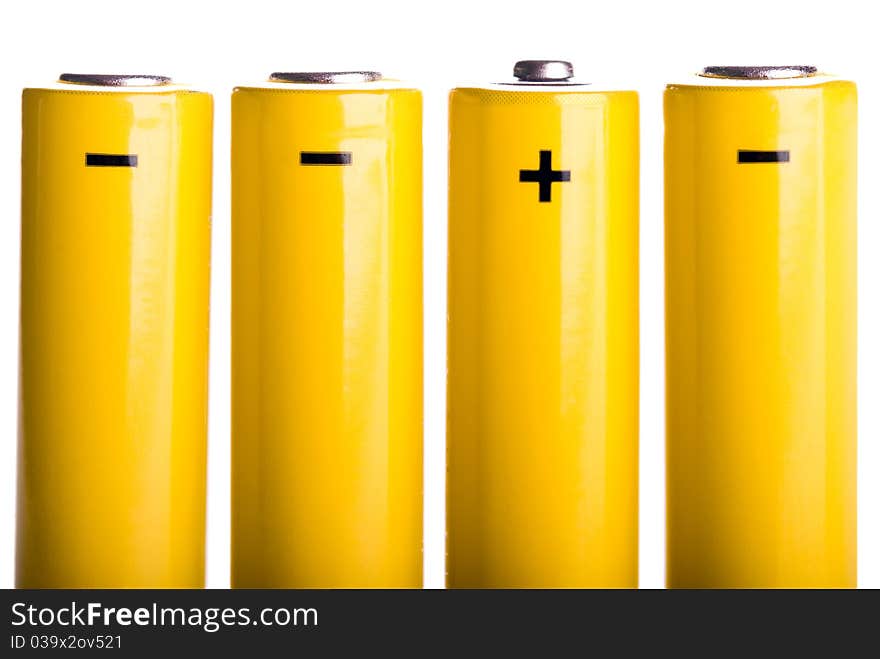 Four yellow batteries standing