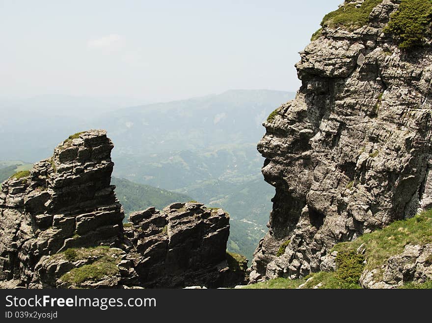 View at valley between rocks. One rock has the shape of human profile. View at valley between rocks. One rock has the shape of human profile