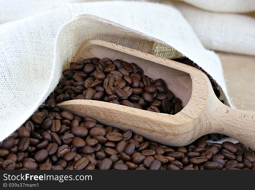 Coffee beans, a sack and a scoop.