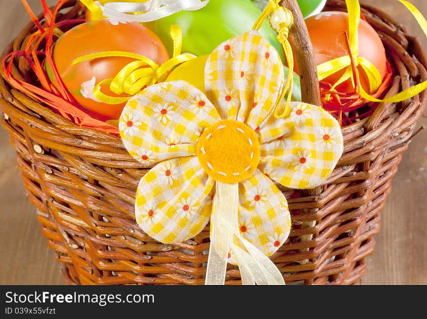 Easter eggs in basket with easter flower