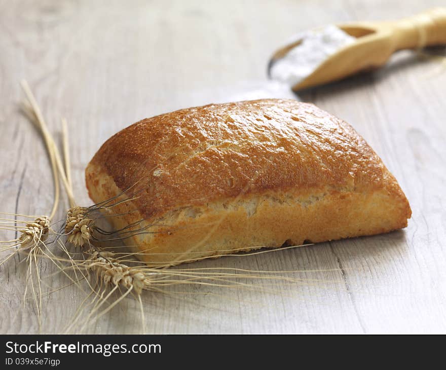 A close up of a baked bread on a wooden surface