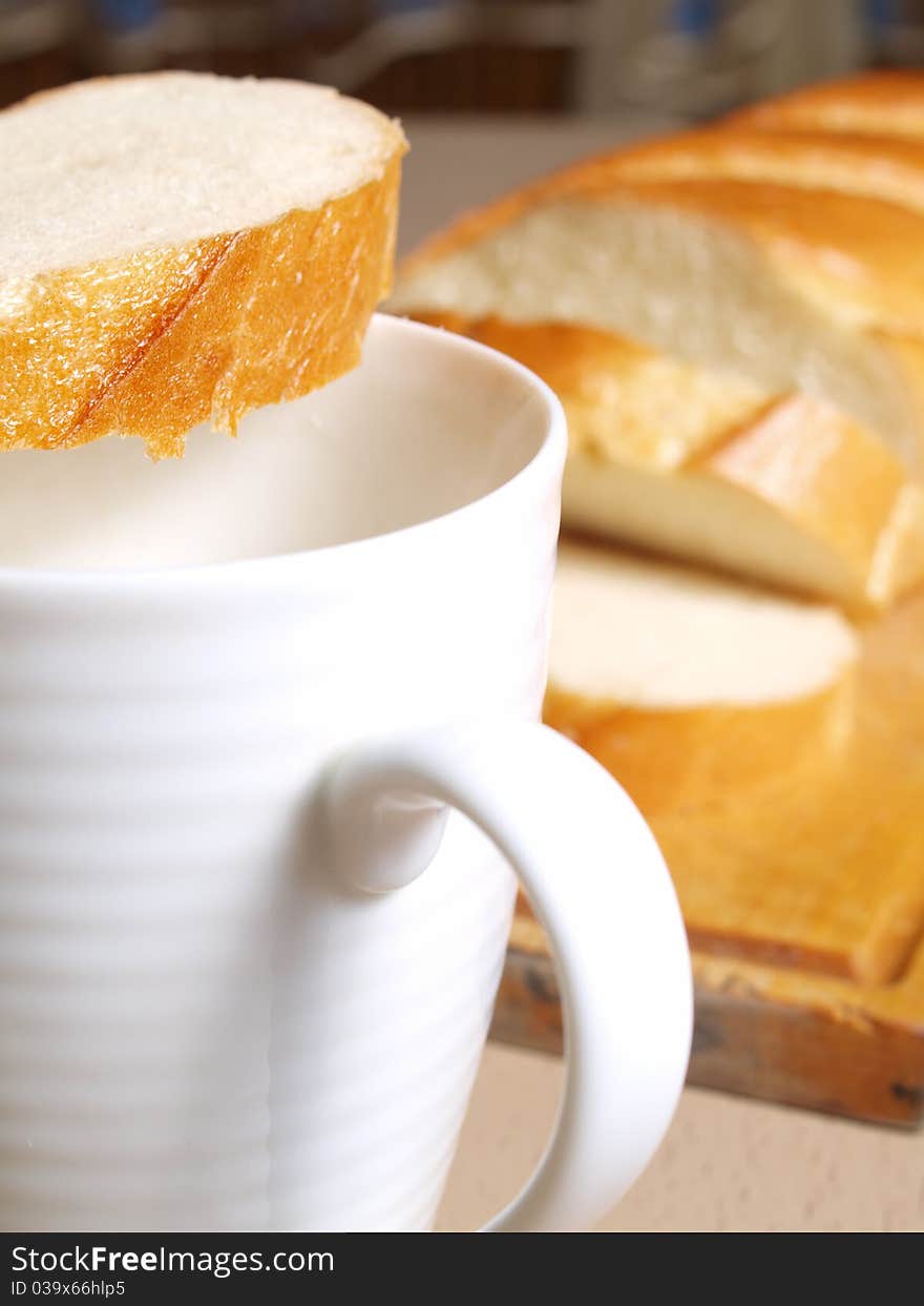 Milk in a mug and bread. Milk in a mug and bread