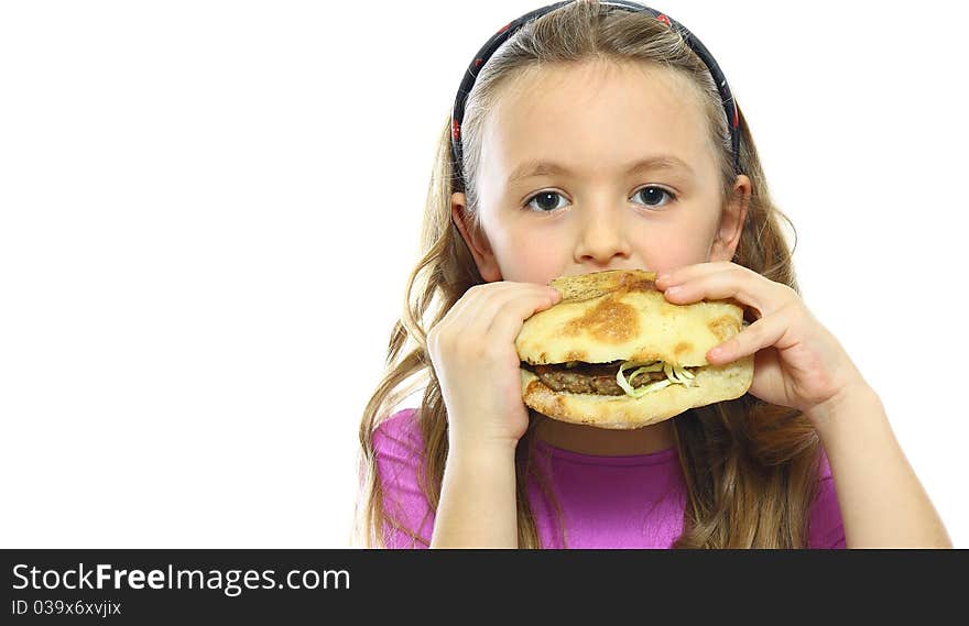 Little girl eating hamburger isolated on white