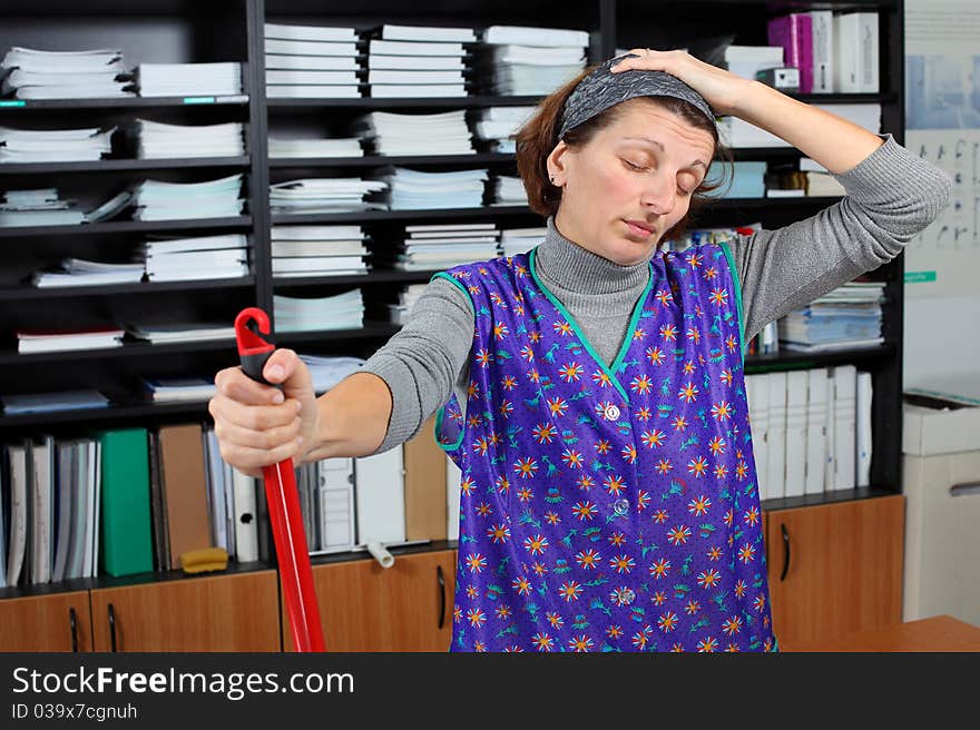 Professional cleaning lady at her work in the office