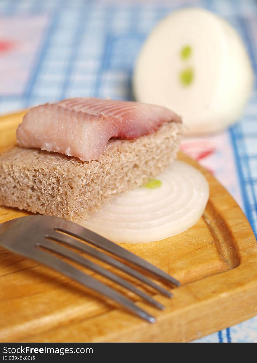 Salted fish, bread and onion closeup. Salted fish, bread and onion closeup