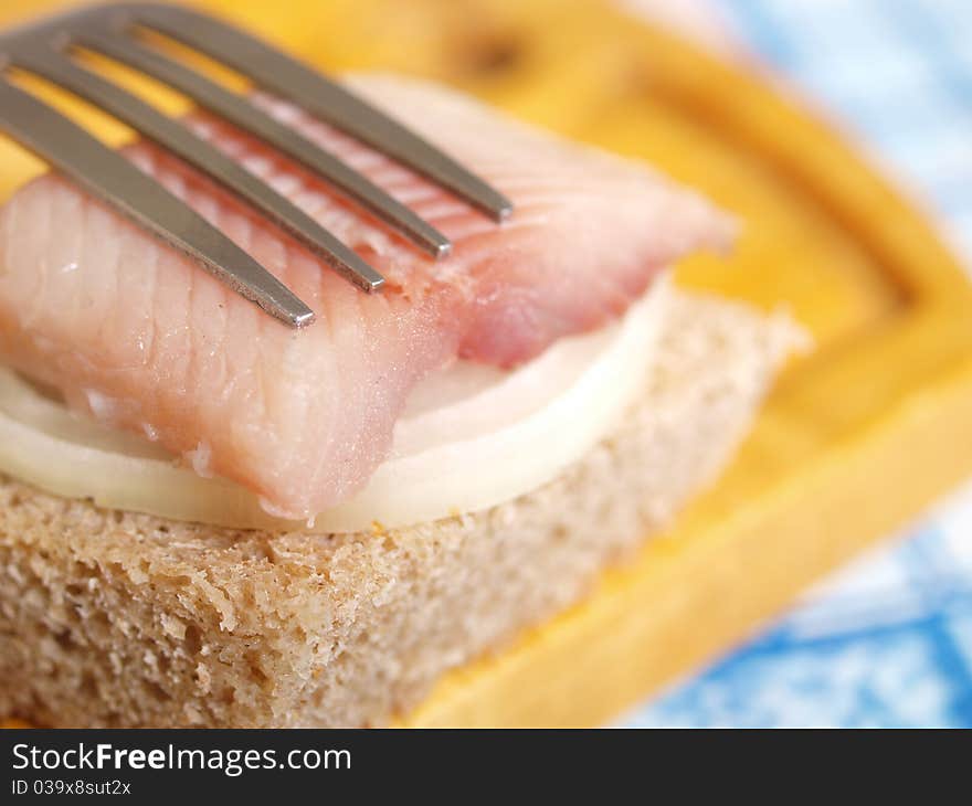 Salted fish, bread and onion closeup. Salted fish, bread and onion closeup