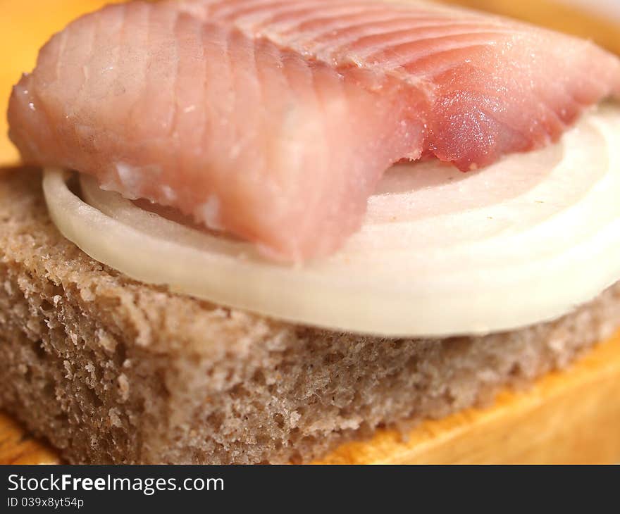 Salted fish, bread and onion closeup. Salted fish, bread and onion closeup