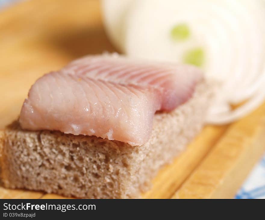 Salted fish, bread and onion closeup. Salted fish, bread and onion closeup