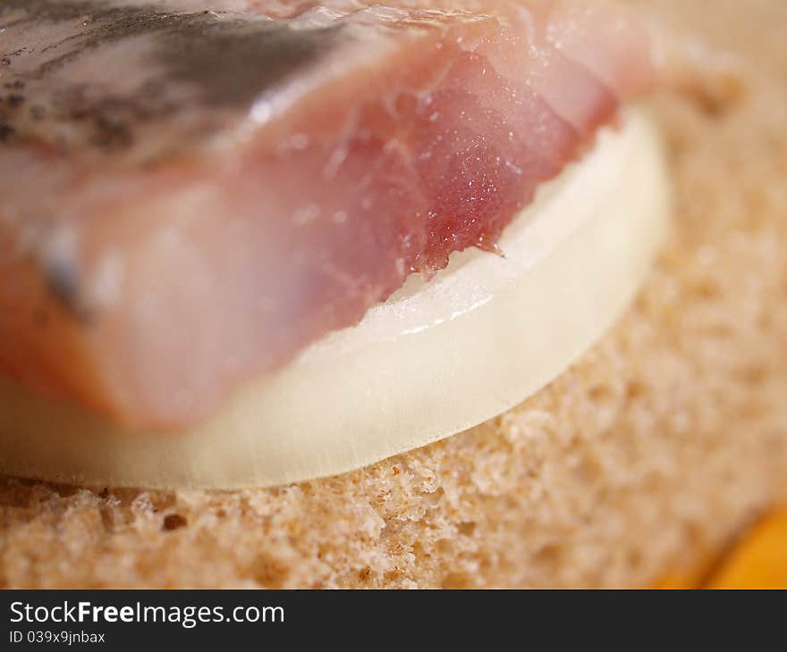 Salted fish, bread and onion closeup. Salted fish, bread and onion closeup