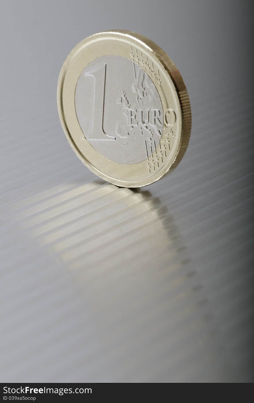 One Euro coin to a metal plate