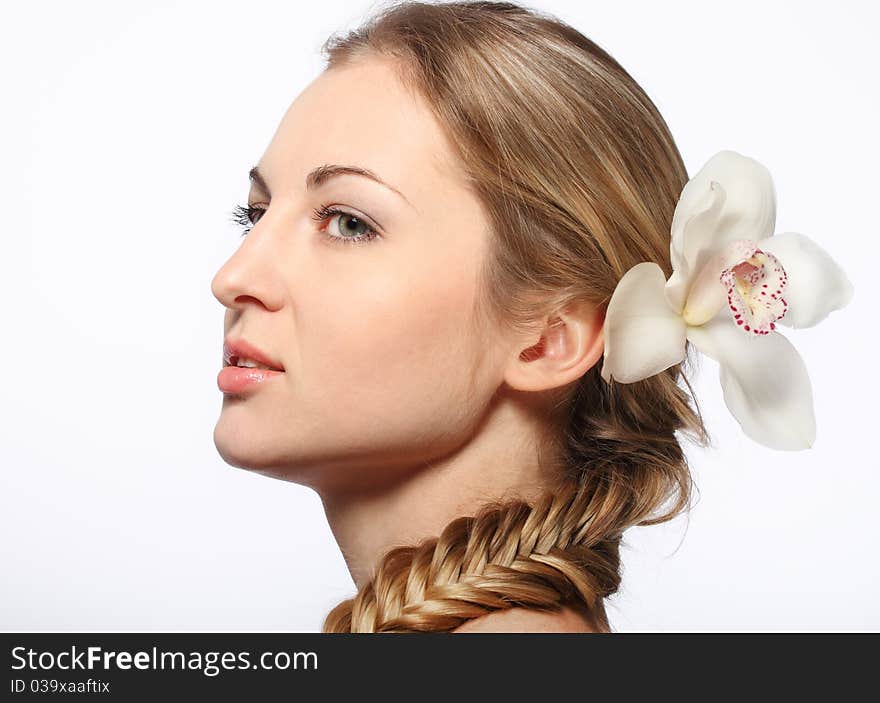 Portrait of the beauty young blond girl with orchid in her hair. Portrait of the beauty young blond girl with orchid in her hair