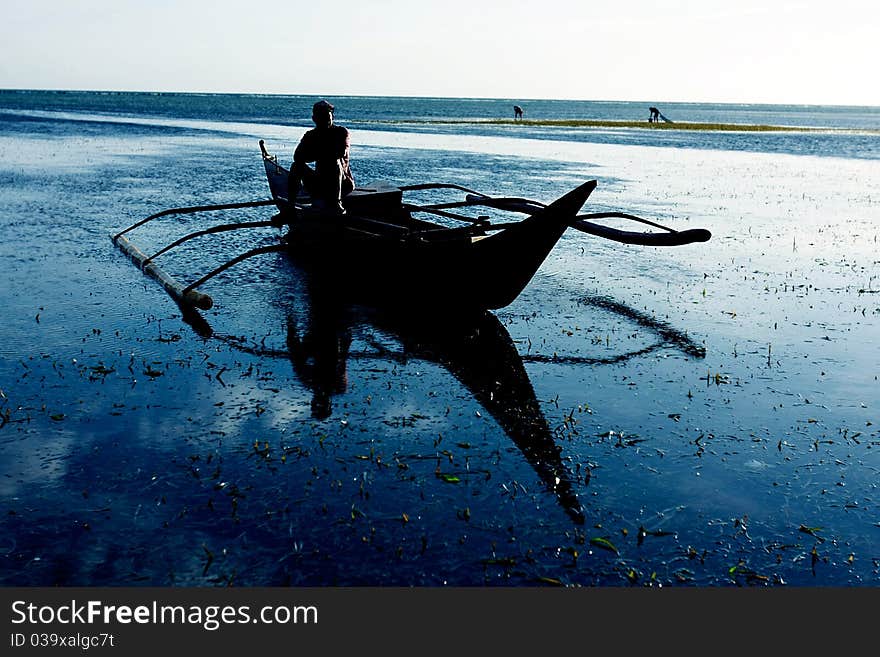 Traditional philippino boat on water at sunrise