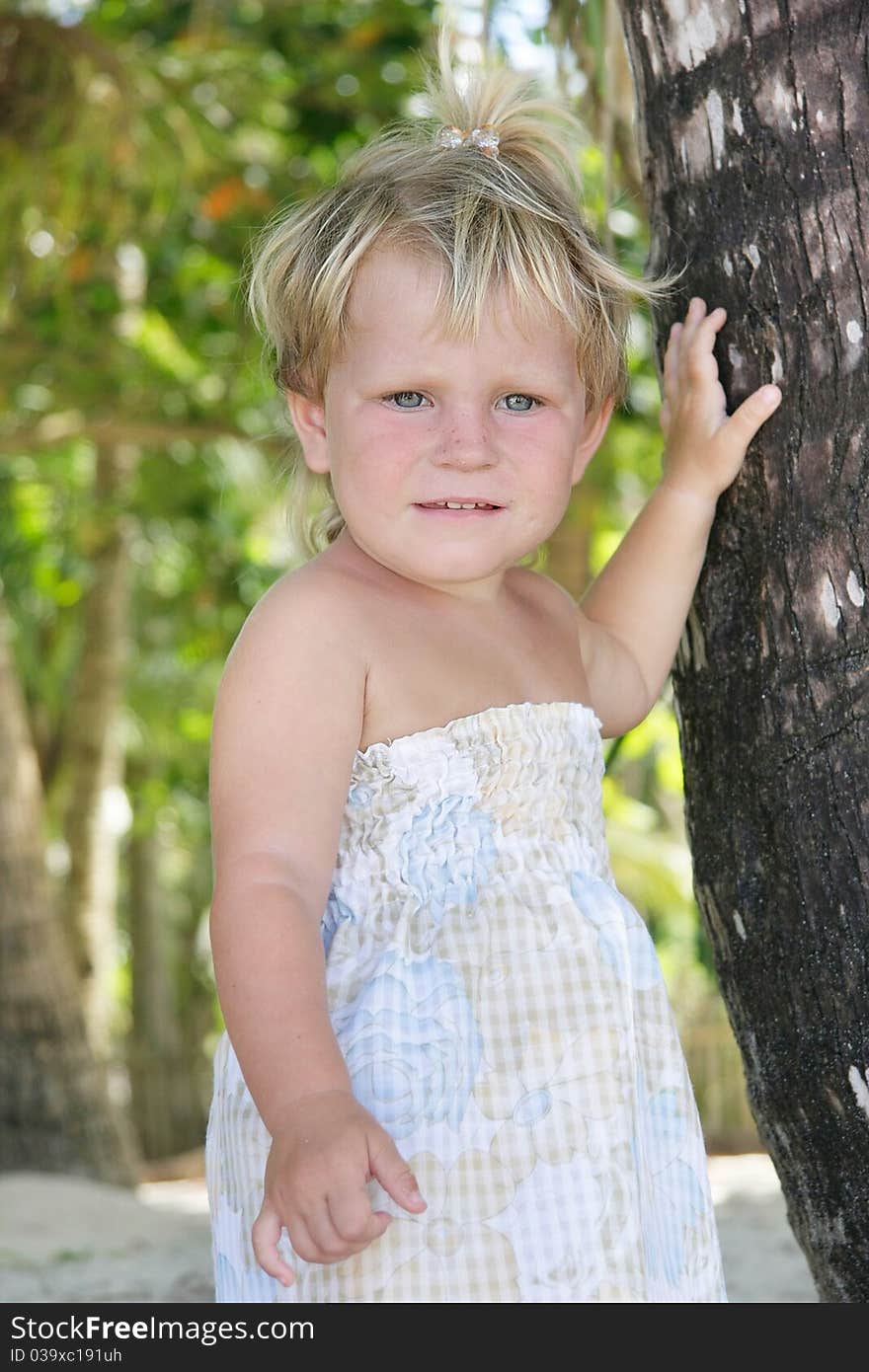 Young girl near palm tree