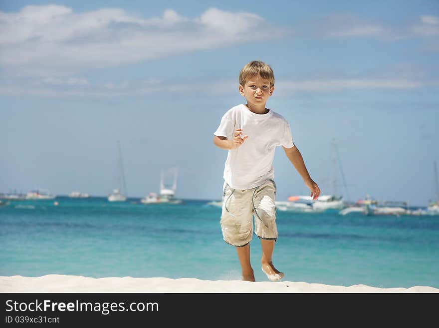 Young boy running on sea background