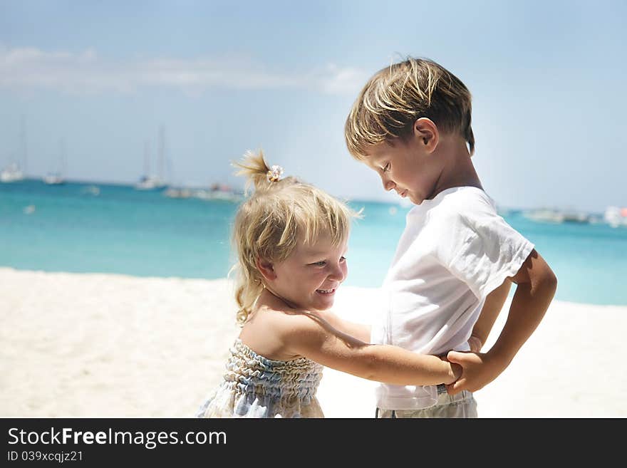 Young brother and sister on sea background