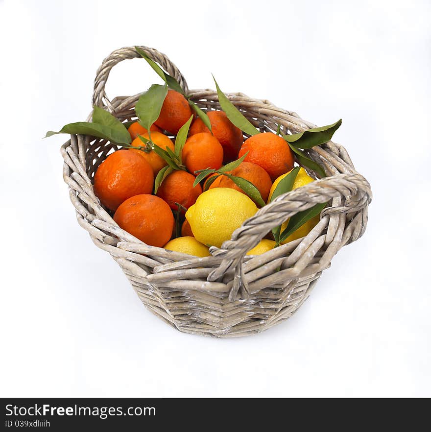 A basket full of citrus fruit. A basket full of citrus fruit