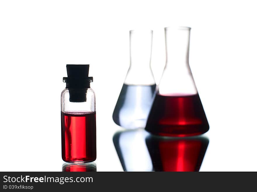 Laboratory flasks with liquid. White background. Studio shot. Laboratory flasks with liquid. White background. Studio shot.