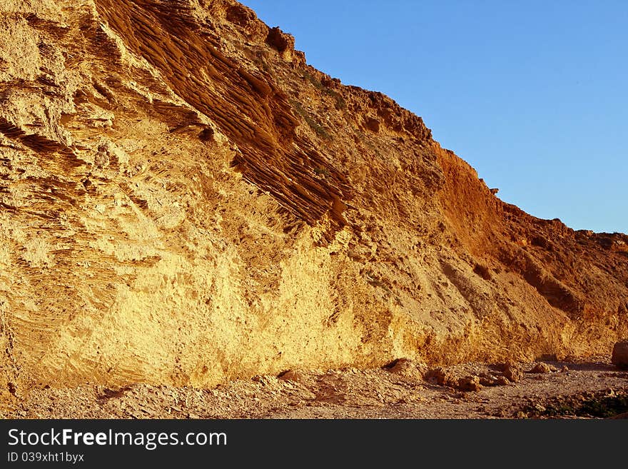 View of ancient coastal wall with original texture of limestone. Mediterranean. View of ancient coastal wall with original texture of limestone. Mediterranean.