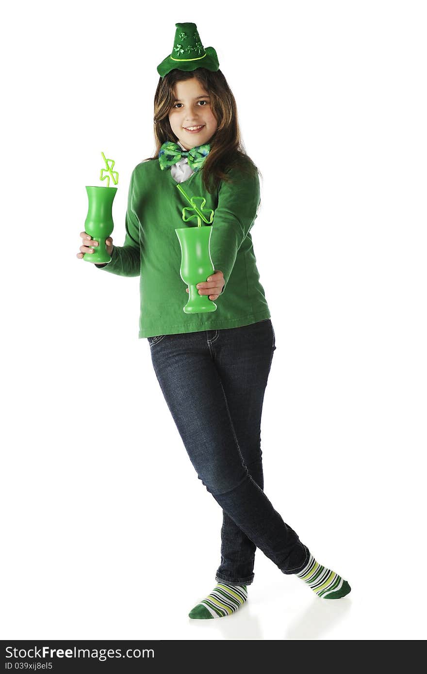 An attractive young teen offering the viewer one of her two green mugs with shamrock-shaped straws. Isolated on white. An attractive young teen offering the viewer one of her two green mugs with shamrock-shaped straws. Isolated on white.