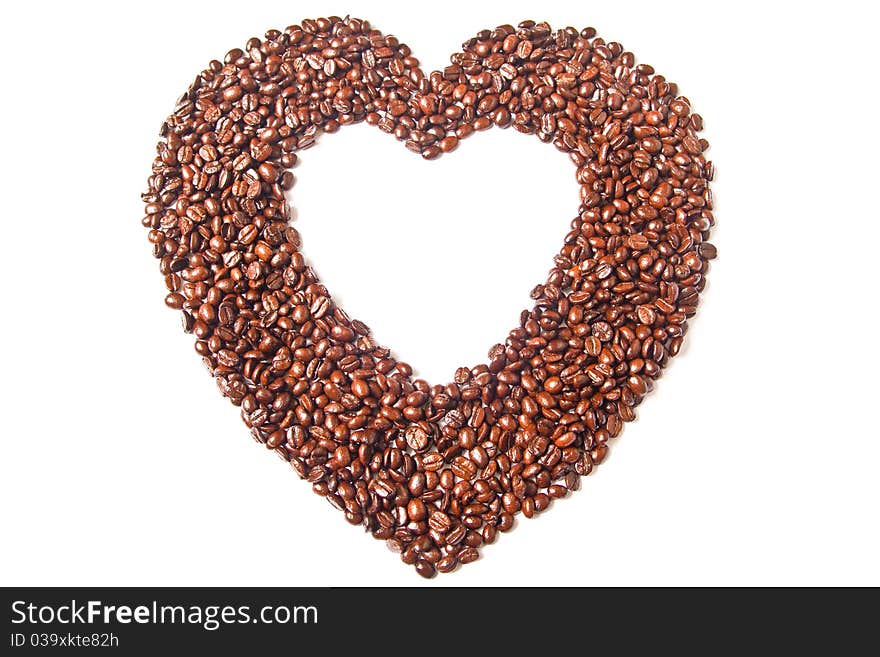 Heart from brown coffee beans on white background