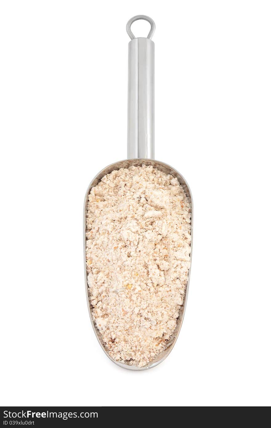 Wholegrain flour in a stainless steel metal scoop over white background.