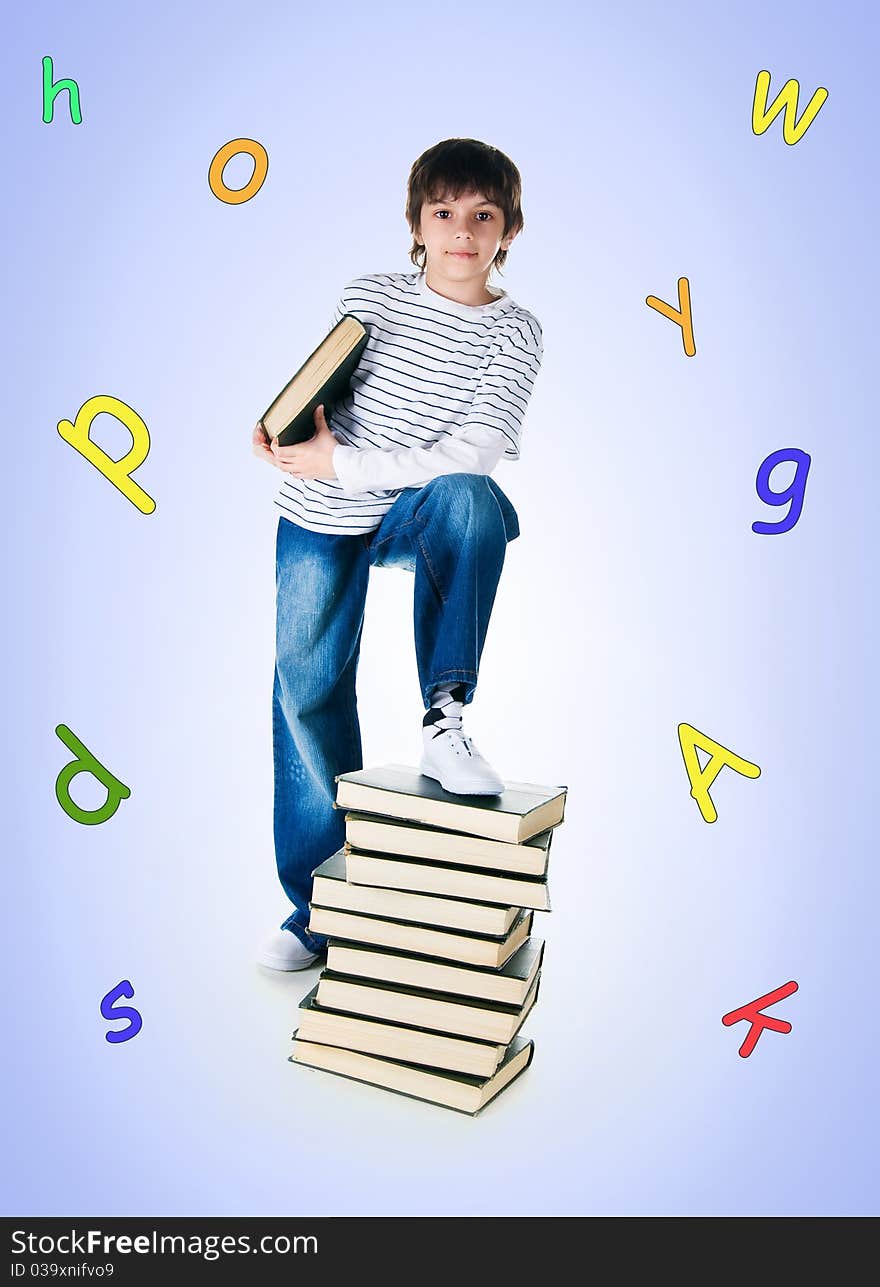 Cute little boy near the stack of big books on white background