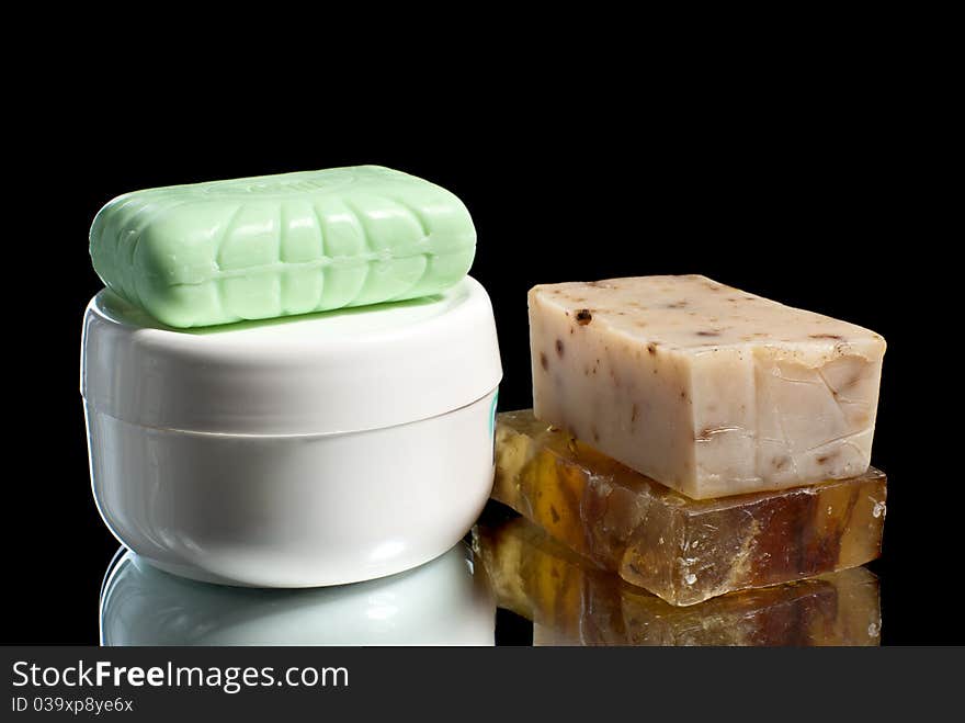 Soap pieces with cream. Black background. Studio shot. Soap pieces with cream. Black background. Studio shot.