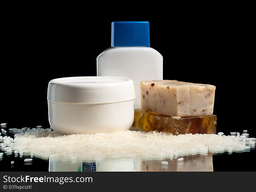 Soap pieces with rice, cream and cosmetic bottle. Soap pieces with rice, cream and cosmetic bottle.