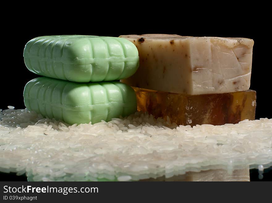 Soap pieces with rice. Black background. Studio shot. Soap pieces with rice. Black background. Studio shot.