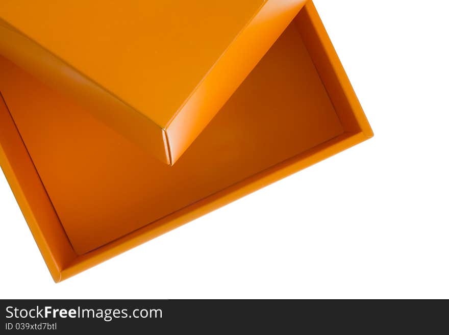 Orange cardboard box on the top of the frame isolated on white background. Orange cardboard box on the top of the frame isolated on white background