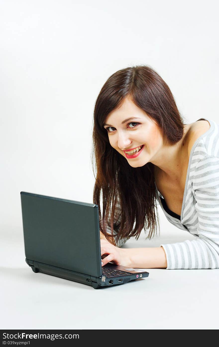 Girl with a laptop on a gray background. Girl with a laptop on a gray background