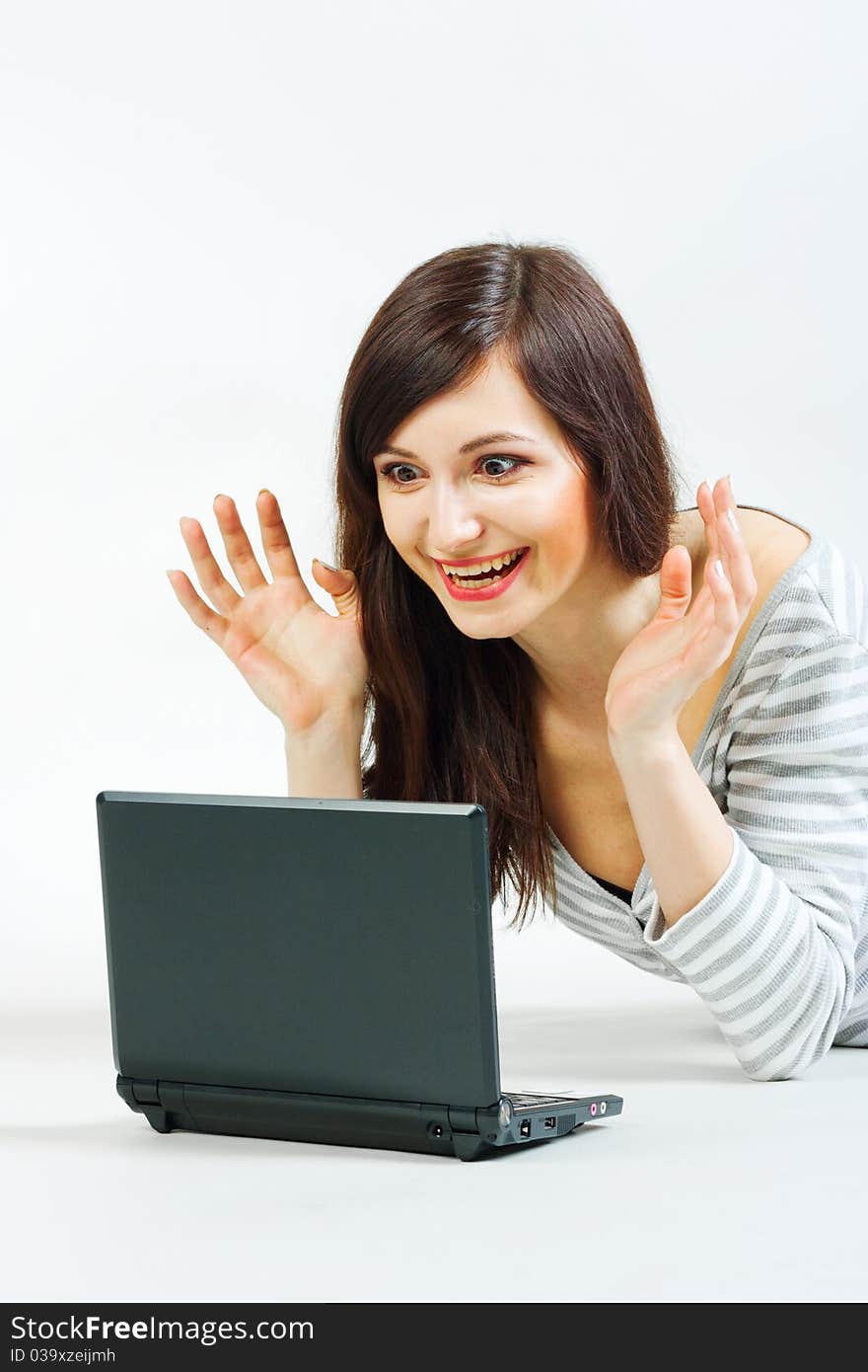 Girl with a laptop on a gray background. Girl with a laptop on a gray background