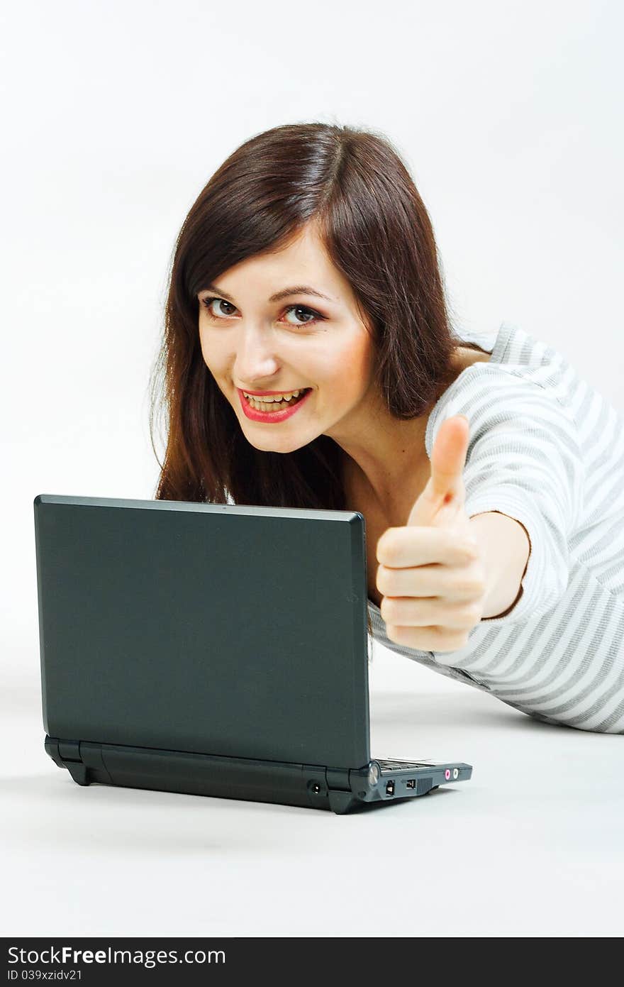 Girl with a laptop on a gray background. Girl with a laptop on a gray background