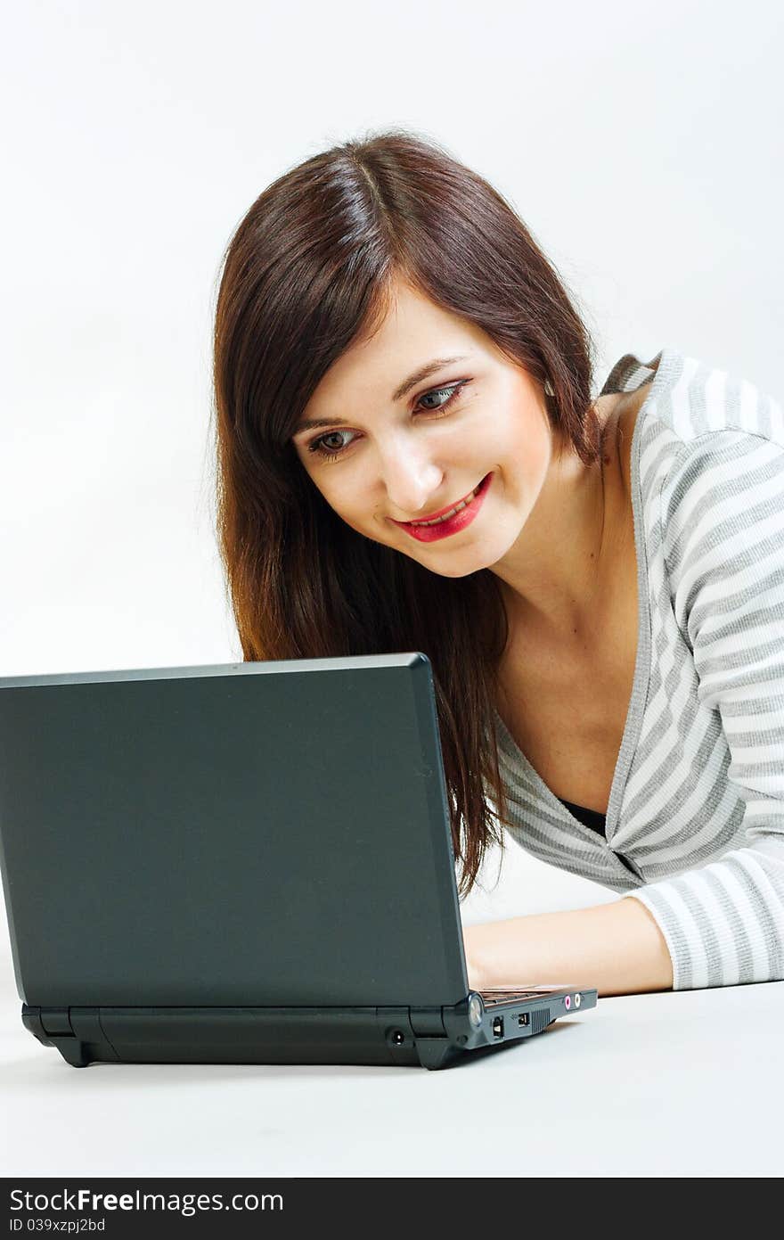 Girl with a laptop on a gray background. Girl with a laptop on a gray background