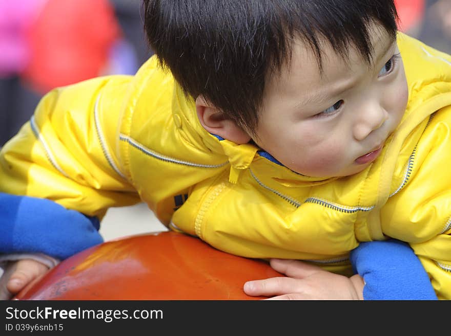 A cute baby is playing in a park. A cute baby is playing in a park