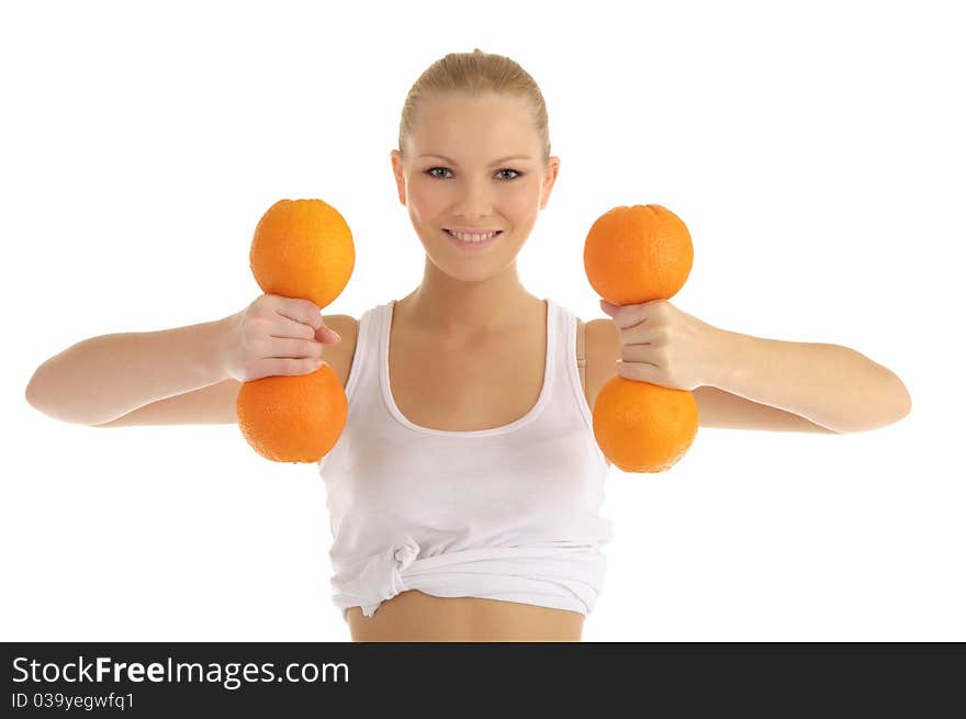 Woman engaged in fitness dumbbells of oranges