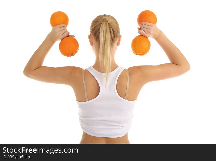 Woman engaged in fitness dumbbells of oranges