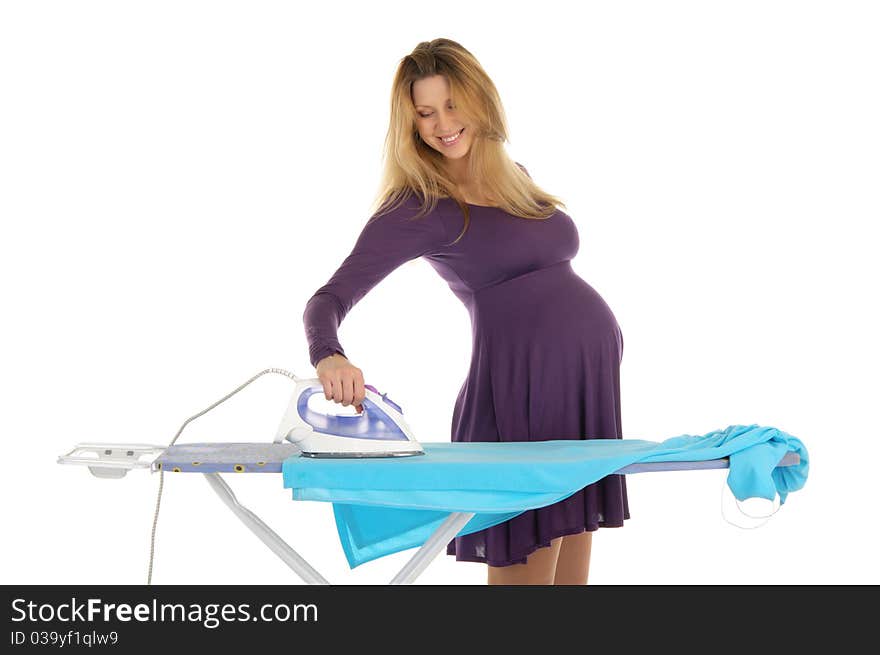 Pregnant woman in a purple dress with an iron isolated on white