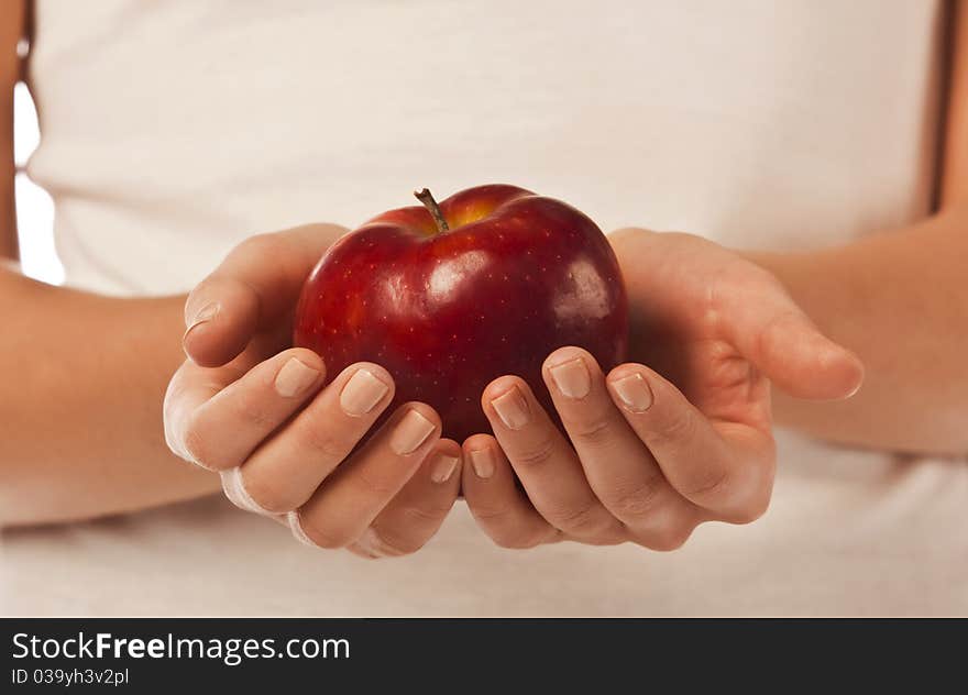 Fresh red apple in a woman hand