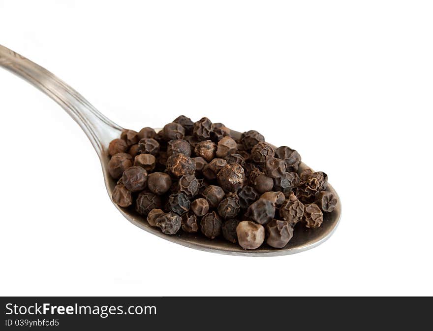 Tea spoon whith black pepper isolated on white background. Tea spoon whith black pepper isolated on white background