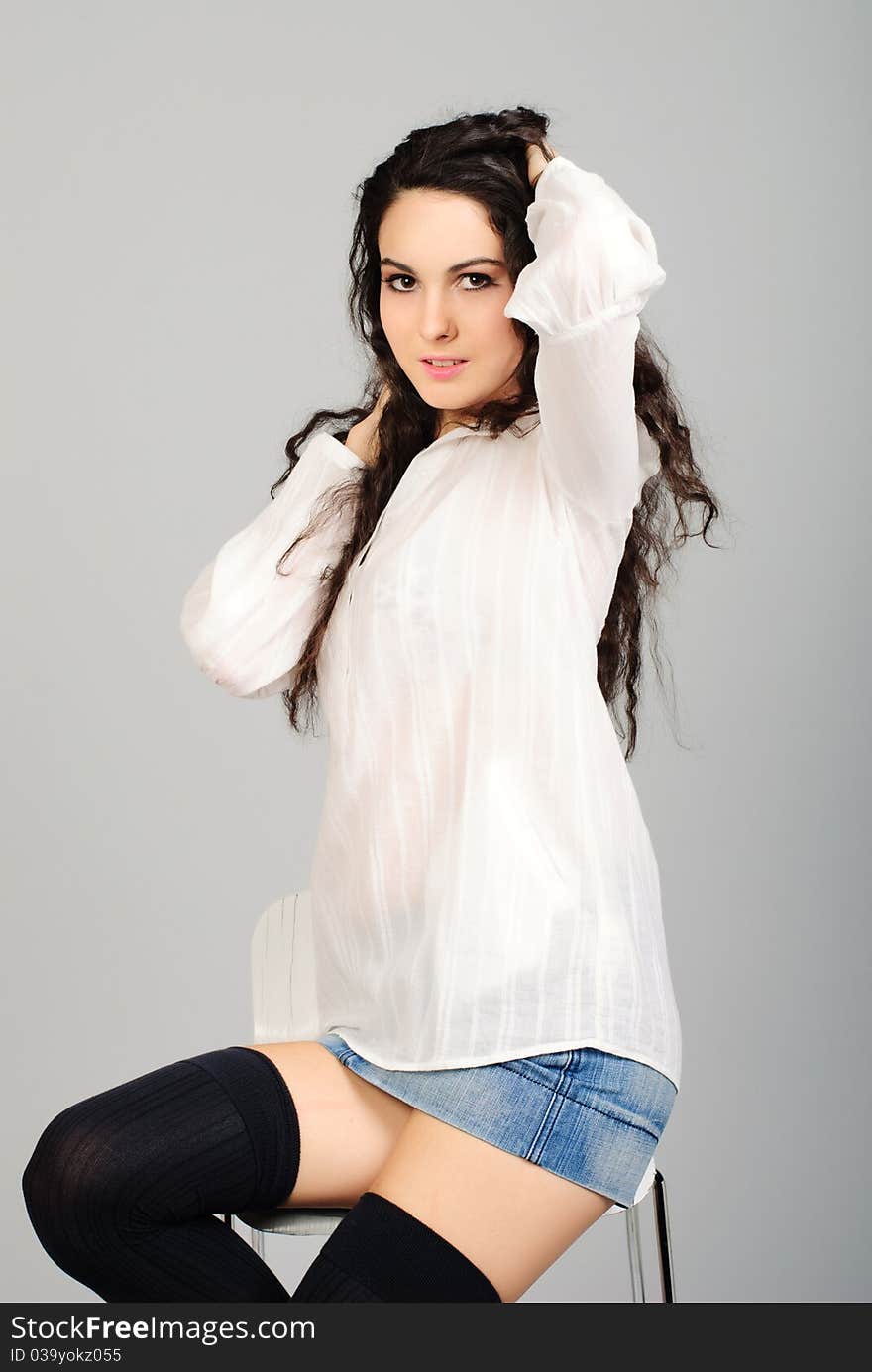 Beautiful young brunet woman in white shirt studio shoot. Beautiful young brunet woman in white shirt studio shoot