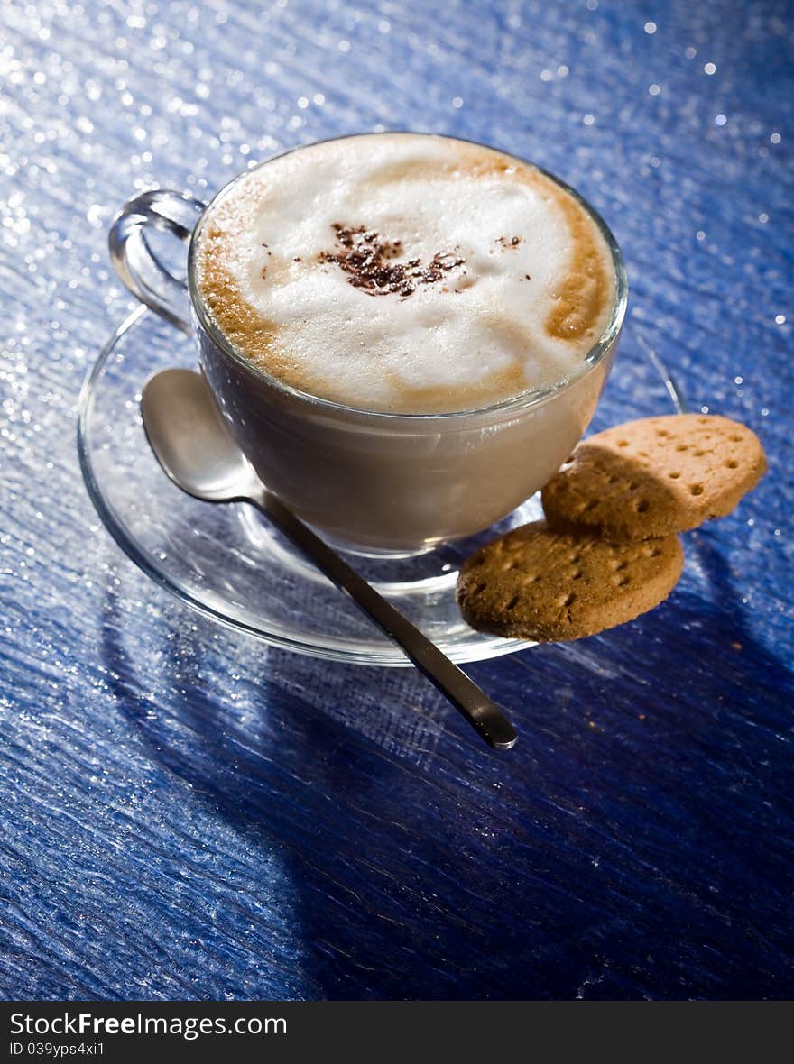 Cappuccino on blue glass table