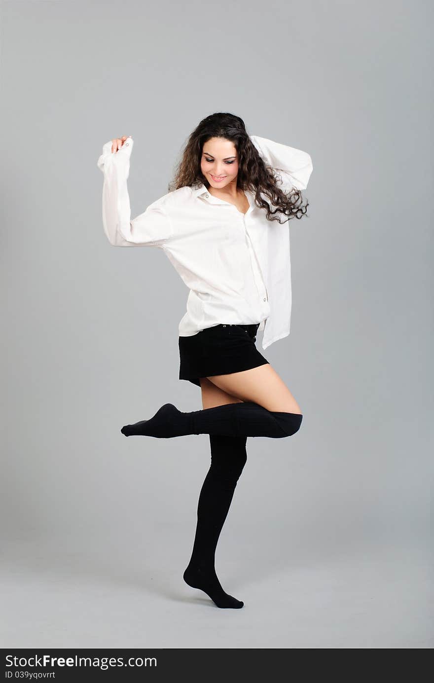 Beautiful young brunet woman in white shirt studio shoot. Beautiful young brunet woman in white shirt studio shoot