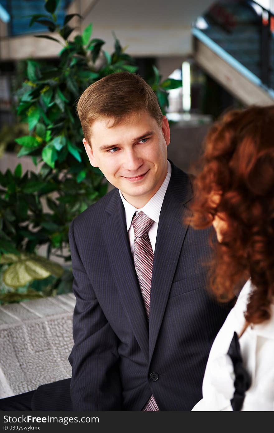 Man In Business Suit Looks At Woman Gently