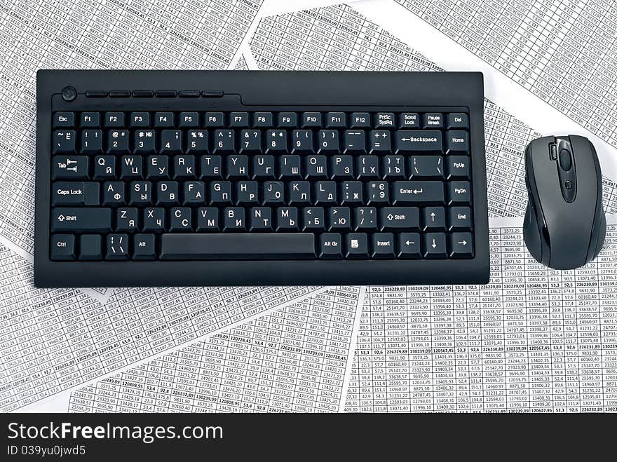 PC keyboard and mouse on a spreadsheets.