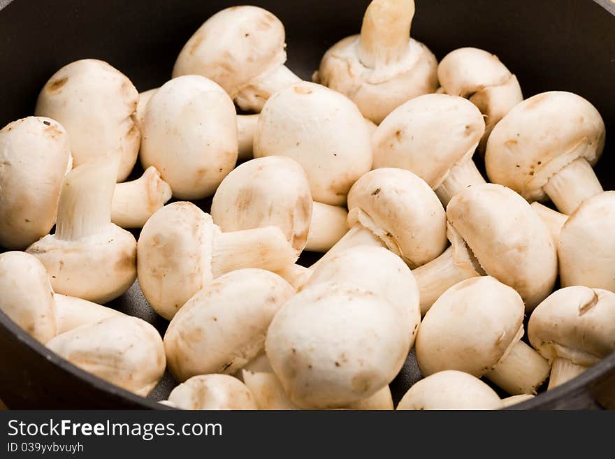 Photo of delicious raw mushroomw on chopping board. Photo of delicious raw mushroomw on chopping board