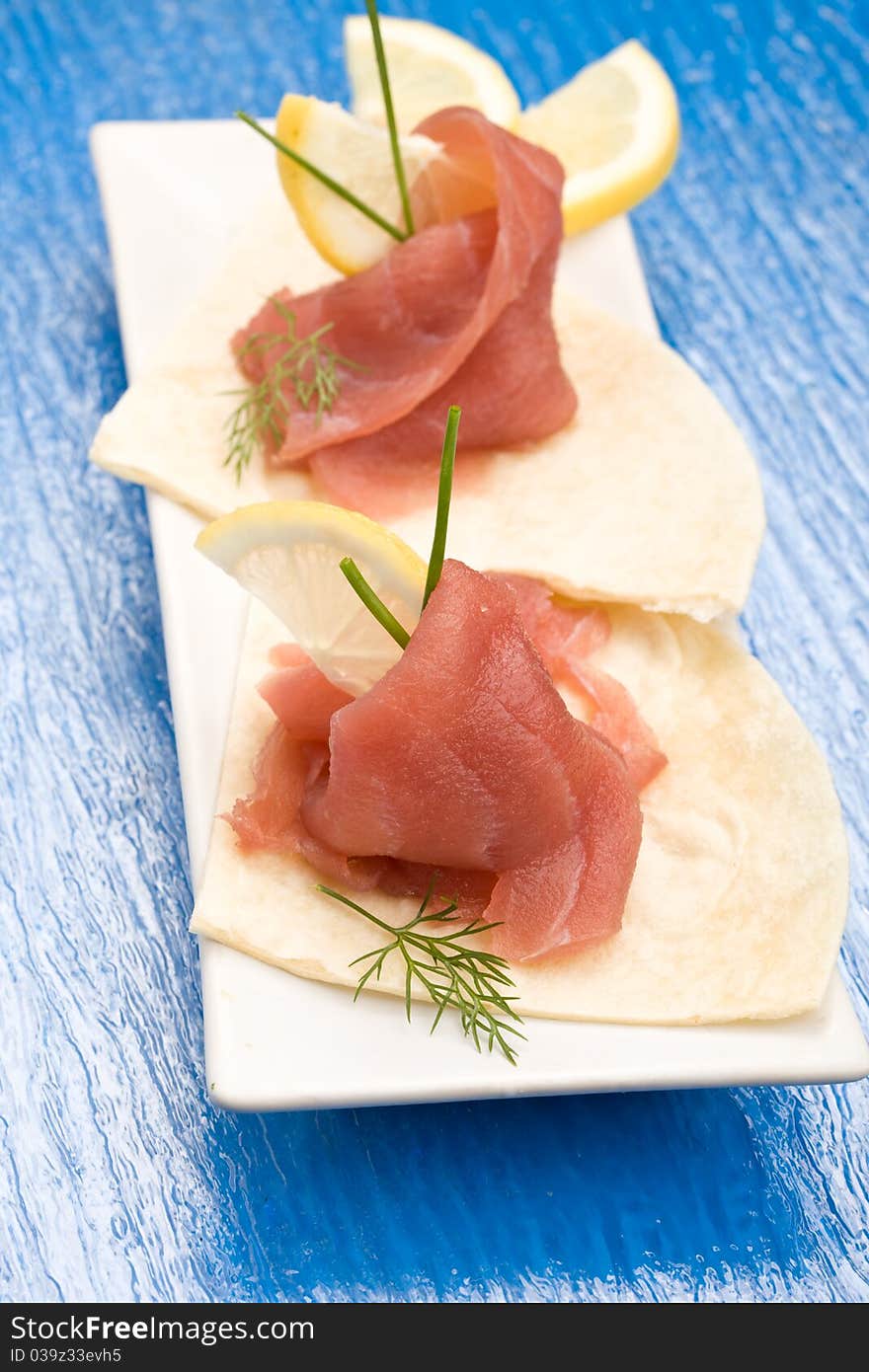 Photo of delicious tuna sleces on flat bread with lemon and fennel. Photo of delicious tuna sleces on flat bread with lemon and fennel